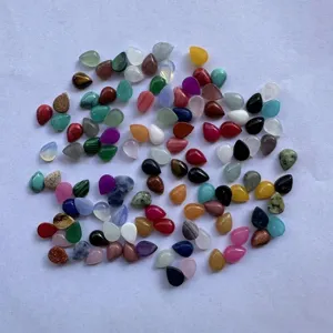 Close-up of assorted 6x8mm teardrop natural stone cabochons for DIY jewelry making