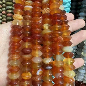 Macro view showing the natural texture of orange agate flying saucer beads for DIY