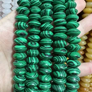 Macro view of green malachite pattern lentil shaped spacer beads for DIY jewelry making