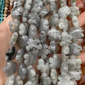 Close-up view of grey natural stone beads in flower shape for DIY jewelry crafting