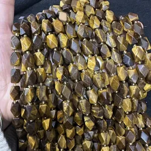 Close-up of faceted brown tiger eye natural stone beads for DIY necklace jewelry making.