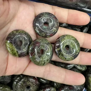 Detail view of 25mm natural stone donut pendants for DIY jewelry making accessories