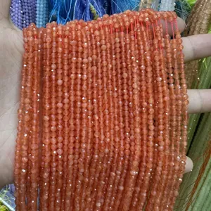 Detailed view of orange 3mm faceted cat's eye round beads for DIY jewelry making crafts