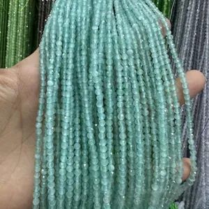 Close-up of 3mm faceted green cat-eye stone beads for DIY jewelry making.