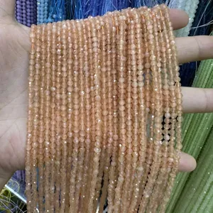 Detailed close-up view of 3mm faceted peach cat's eye round beads for DIY jewelry making material