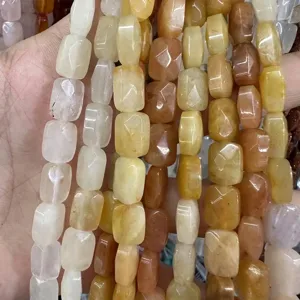 Close-up of faceted rectangular natural stone beads in varied earthy colors for DIY jewelry