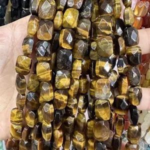 Close-up view of faceted natural Tiger's Eye rectangular loose beads for DIY jewelry making