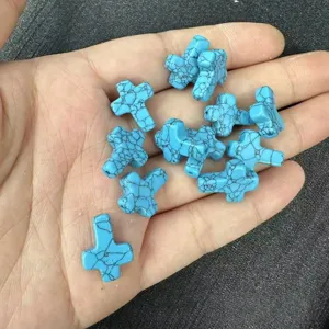 Close-up of small blue turquoise cross beads with black veins and vertical hole design