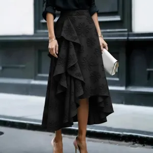 Close-up detail of the black embroidered floral midi skirt featuring an asymmetrical ruffle hem.