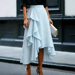 Detail view of the elegant light blue midi skirt featuring stunning floral embroidery and ruffles.