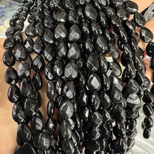 Close-up of faceted teardrop shaped black agate loose beads for DIY jewelry making