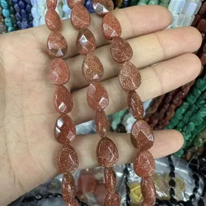 Macro view of faceted teardrop goldstone beads with copper sparkles for DIY jewelry