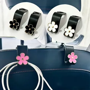Detail shot of cute floral car seat back hooks, metal hooks with colorful flower decor.