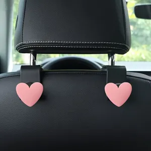 Pink heart car seat headrest hook interior organization accessory detail close up view