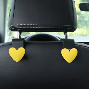 Cute yellow heart car seat back hook, universal vehicle headrest organizer interior accessory.