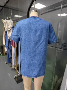 Back detail view of women's casual denim short sleeve lapel top in classic blue wash.