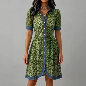Green leopard print dress with denim patchwork, short sleeves and A-line silhouette for women.