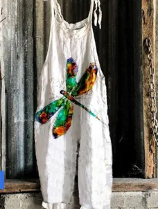 Detail shot showing the colorful dragonfly pattern printed on the white summer women jumpsuit.