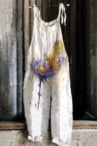 Detail view of the floral print linen jumpsuit, showing the butterfly and flower watercolor graphic.