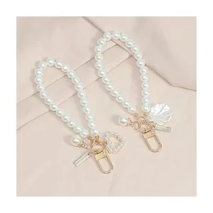 Elegant pearl keychain with cute heart and shell pendant, perfect bag charm accessory.