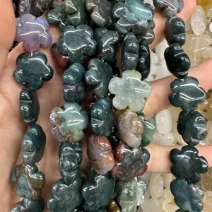 Macro detail of mixed natural stone plum blossom flower beads for DIY jewelry making