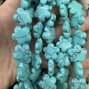 Detail view of plum blossom shaped turquoise stone beads with natural black veining for DIY