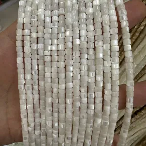 Macro detail showing natural white square shell beads for DIY handmade jewelry crafts