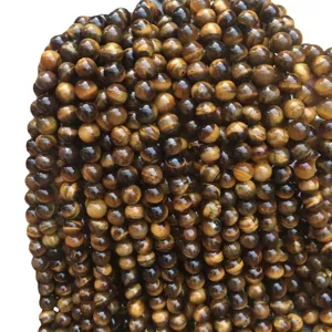 Natural polished round tiger eye stone beads for DIY jewelry making and handmade bracelets.
