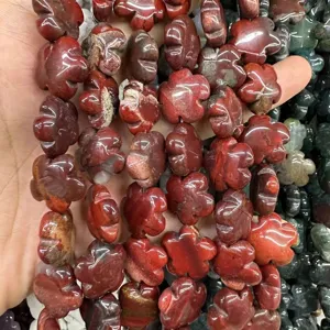 Detailed view of red natural stone flower shaped beads for DIY jewelry making crafts