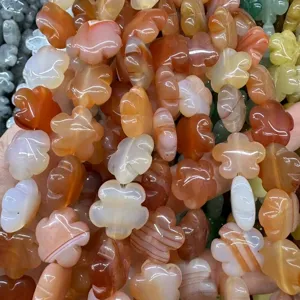 Detailed macro view of natural orange agate flower beads for DIY jewelry making.