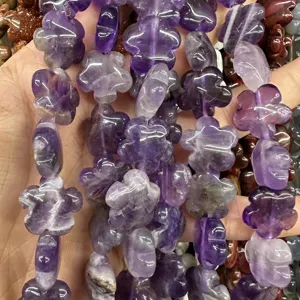 Macro detail of purple amethyst flower-shaped loose beads for jewelry making