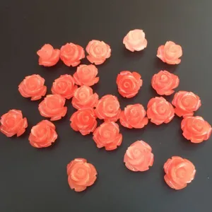 Detailed macro view of pink shell powder rose flower beads for DIY crafts