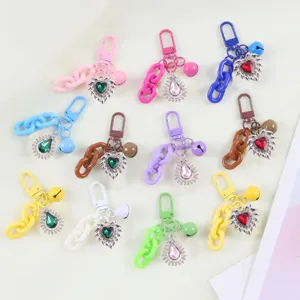 Colorful DIY keychain pendant set featuring crystal heart and teardrop charms with cute bells.