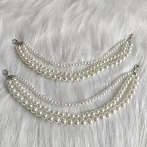 Detailed view of multi-layer white pearl chain accessories with metal clasps for DIY shoes and bags.