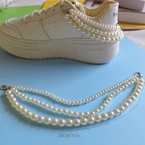 Closeup of multi-layer pearl chain shoe accessory showing detailed bead size and length.