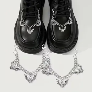 Close up detail of gothic bat shoe chains with metal links for stylish boots decor part.