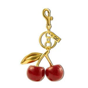 Gold cherry keychain with sparkling red fruit pendant and initial R charm for bags.