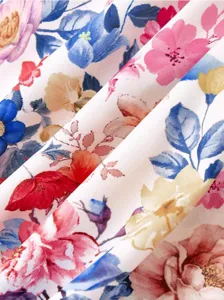 Close-up detail of a vibrant watercolor floral fabric showing delicate pink, blue and yellow print.