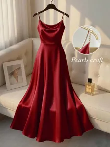 Elegant red satin maxi dress featuring delicate pearl straps and a flattering waist design.