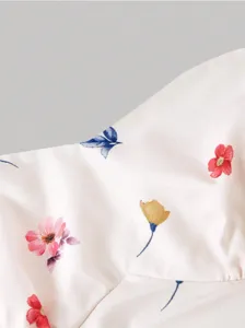 Close-up detail of the pink floral fabric featuring delicate colorful prints, soft and elegant.
