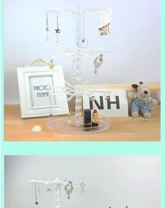 Clear acrylic rotating jewelry display stand for earrings, keychains, and small accessories.