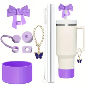Stanley style tumbler set with purple silicone bow straw covers, cup boot, and charm.