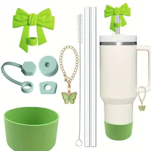 Details of tumbler accessory set including green bow straw topper, cup boot and butterfly chain.
