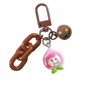 Süßer Pfirsich Puppen Schlüsselanhänger mit brauner grober Kette und Glocke, Taschen Deko.