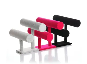 Detail view of double-tier velvet jewelry display stands in various colors for bracelets.