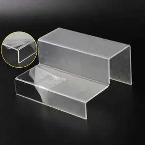 Clear acrylic 2-tier display riser step shelf for action figures and cosmetics showcase.