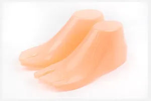 Detail shot of flesh-colored hollow plastic shoe foot mannequin display props for retail shops.