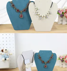 Detail view of necklace display stands, velvet bust jewelry organizer for retail showcase.