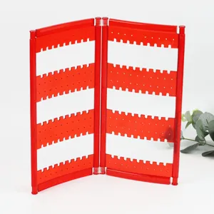 Red plastic folding earring display rack, creative screen jewelry organizer stand detail view.