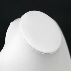 White PU leather necklace display bust neck mannequin for jewelry store showcase retail setup.